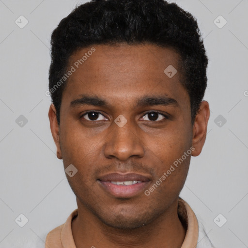 Joyful black young-adult male with short  brown hair and brown eyes