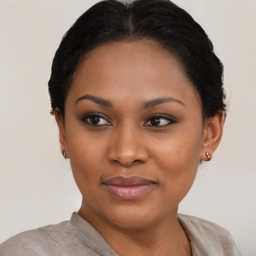 Joyful black young-adult female with short  brown hair and brown eyes
