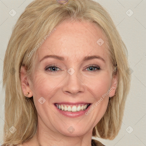 Joyful white adult female with medium  brown hair and blue eyes