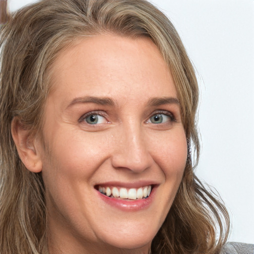 Joyful white adult female with medium  brown hair and green eyes