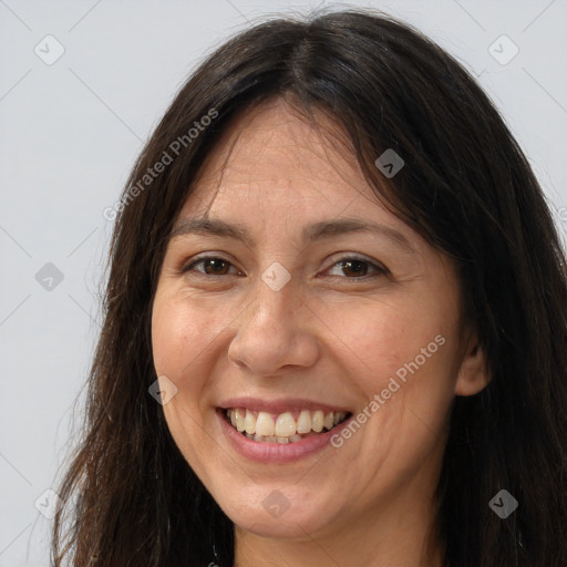 Joyful white adult female with long  brown hair and brown eyes