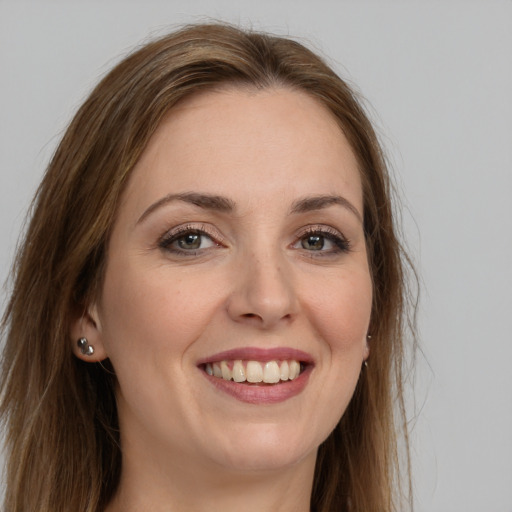 Joyful white young-adult female with long  brown hair and brown eyes