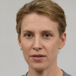 Joyful white adult female with short  brown hair and grey eyes