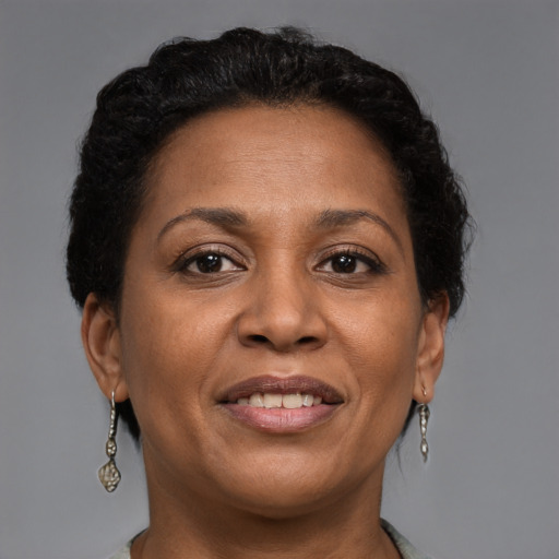 Joyful black adult female with short  brown hair and brown eyes