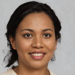 Joyful latino young-adult female with medium  brown hair and brown eyes