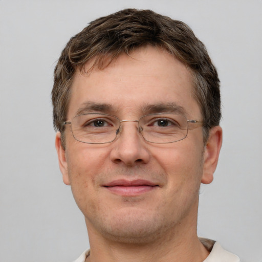 Joyful white adult male with short  brown hair and grey eyes