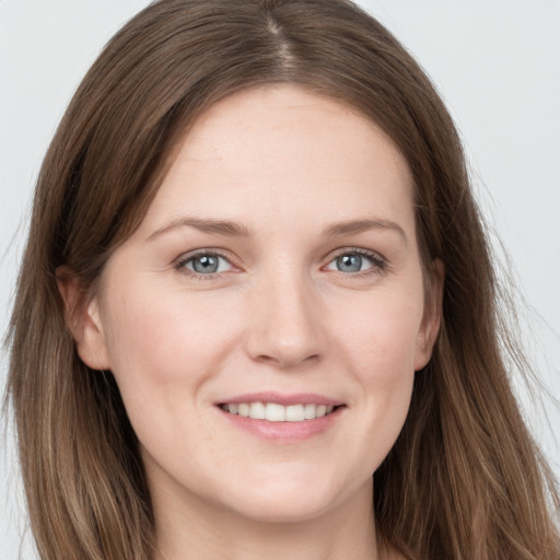 Joyful white young-adult female with long  brown hair and grey eyes