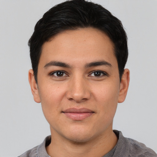 Joyful white young-adult male with short  black hair and brown eyes