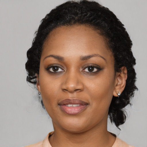 Joyful black young-adult female with medium  black hair and brown eyes