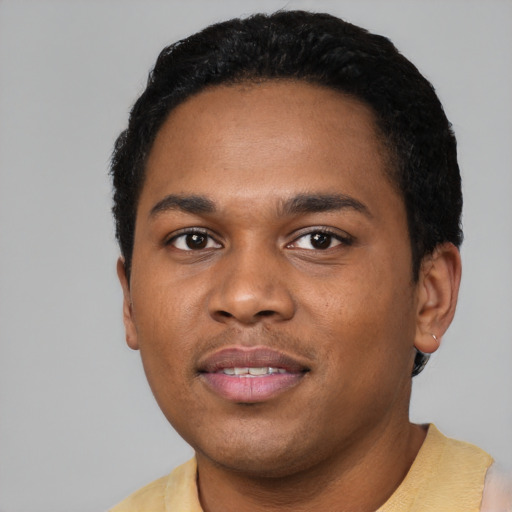 Joyful black young-adult male with short  black hair and brown eyes