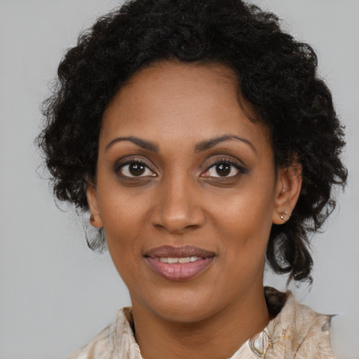 Joyful black young-adult female with medium  brown hair and brown eyes