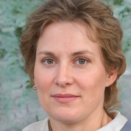 Joyful white adult female with medium  brown hair and blue eyes