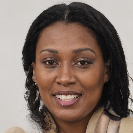 Joyful black adult female with medium  brown hair and brown eyes