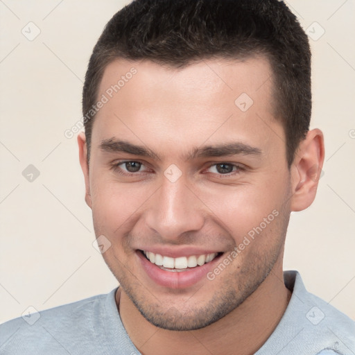 Joyful white young-adult male with short  brown hair and brown eyes