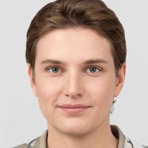 Joyful white young-adult female with short  brown hair and grey eyes