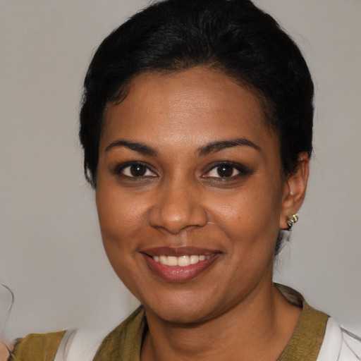 Joyful black young-adult female with medium  black hair and brown eyes