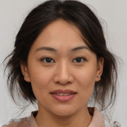 Joyful asian young-adult female with medium  brown hair and brown eyes