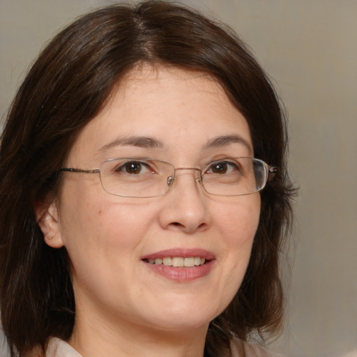 Joyful white adult female with medium  brown hair and brown eyes