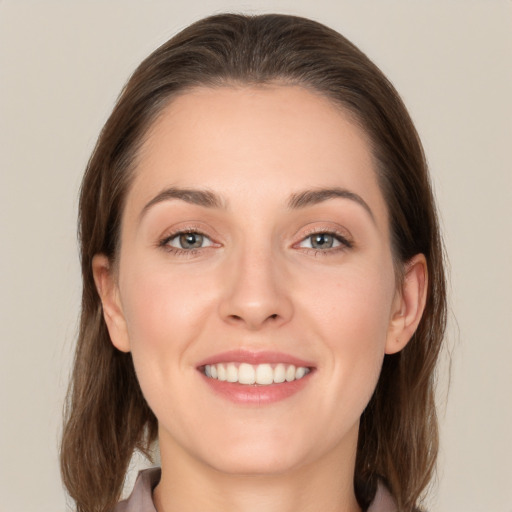 Joyful white young-adult female with long  brown hair and grey eyes