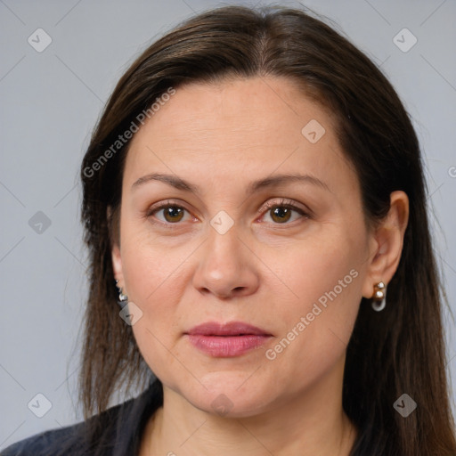 Joyful white adult female with long  brown hair and brown eyes