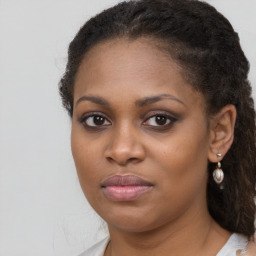 Joyful black young-adult female with medium  brown hair and brown eyes