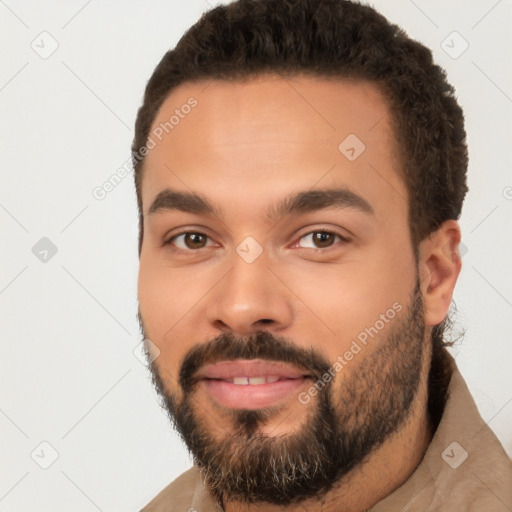 Joyful white young-adult male with short  black hair and brown eyes