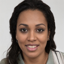 Joyful latino young-adult female with long  brown hair and brown eyes
