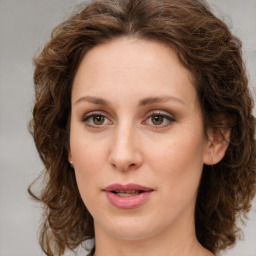 Joyful white young-adult female with medium  brown hair and green eyes