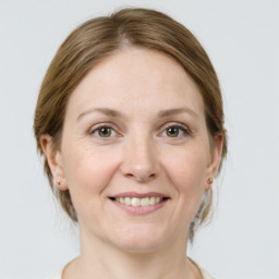 Joyful white adult female with medium  brown hair and grey eyes