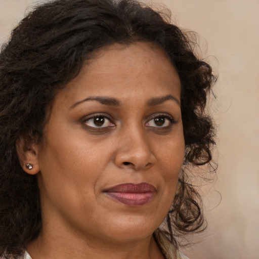 Joyful black young-adult female with medium  brown hair and brown eyes
