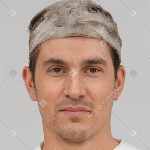 Joyful white adult male with short  brown hair and brown eyes