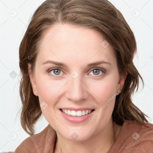 Joyful white young-adult female with medium  brown hair and blue eyes