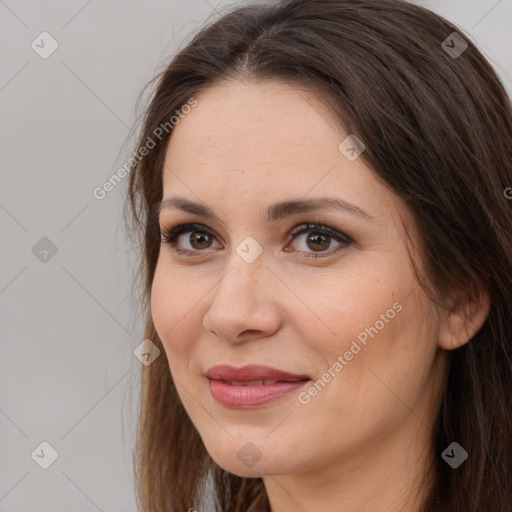 Joyful white adult female with long  brown hair and brown eyes