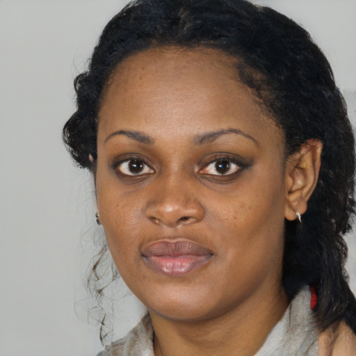 Joyful black young-adult female with medium  black hair and brown eyes