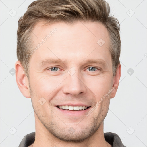 Joyful white adult male with short  brown hair and grey eyes