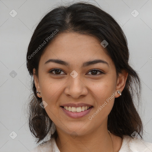 Joyful latino young-adult female with medium  brown hair and brown eyes