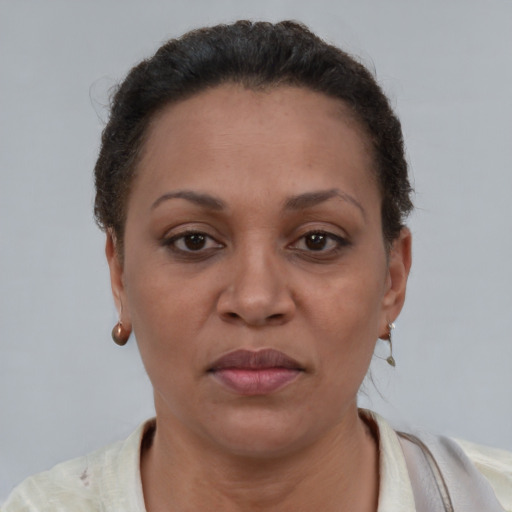 Joyful black adult female with short  brown hair and brown eyes