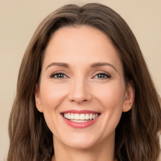 Joyful white young-adult female with long  brown hair and brown eyes