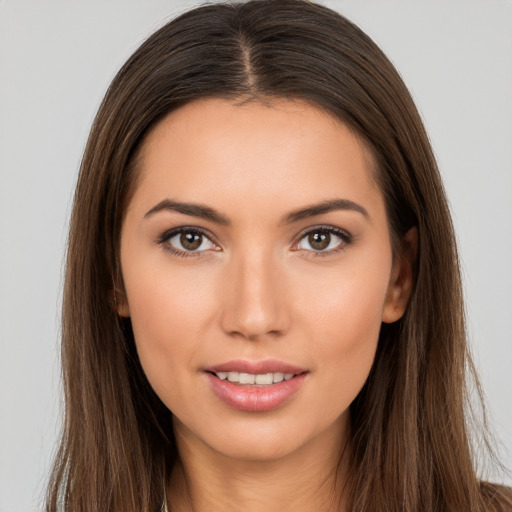 Joyful white young-adult female with long  brown hair and brown eyes