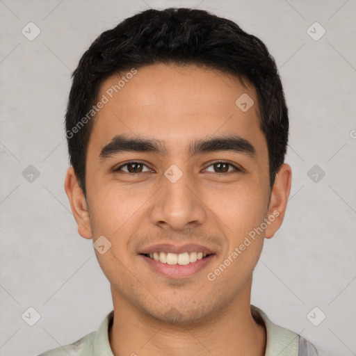 Joyful latino young-adult male with short  black hair and brown eyes