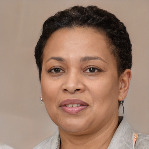 Joyful black adult female with short  brown hair and brown eyes