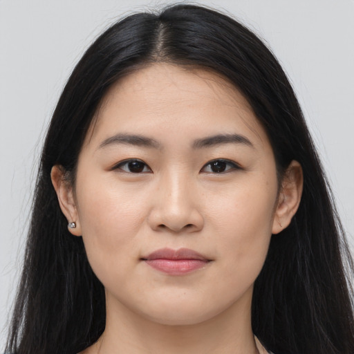 Joyful asian young-adult female with long  brown hair and brown eyes