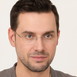 Joyful white young-adult male with short  brown hair and brown eyes