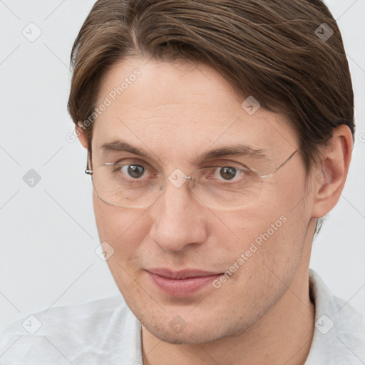 Joyful white adult male with short  brown hair and brown eyes