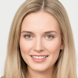 Joyful white young-adult female with long  brown hair and green eyes