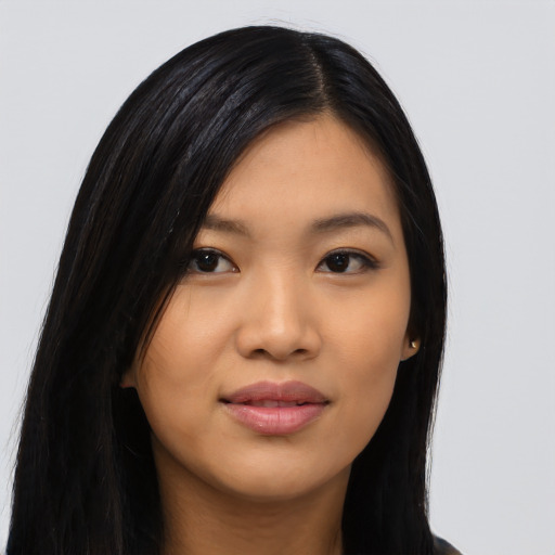 Joyful asian young-adult female with long  black hair and brown eyes