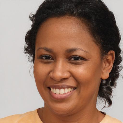 Joyful black young-adult female with medium  brown hair and brown eyes