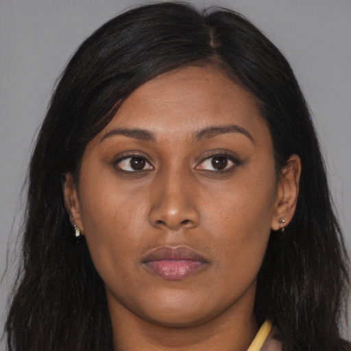 Joyful asian young-adult female with long  brown hair and brown eyes