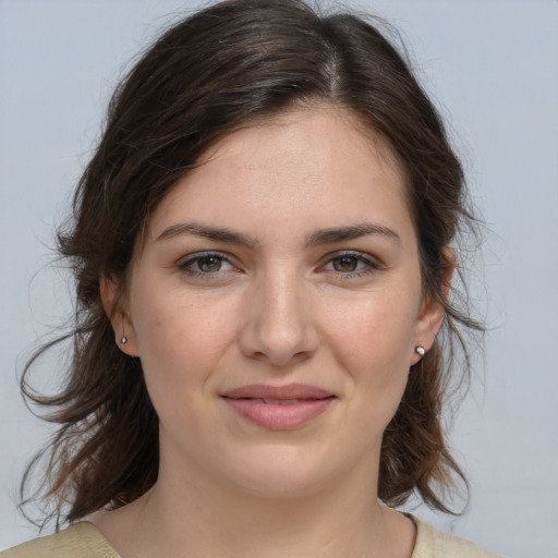 Joyful white young-adult female with medium  brown hair and brown eyes