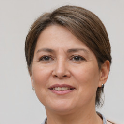 Joyful white adult female with medium  brown hair and grey eyes